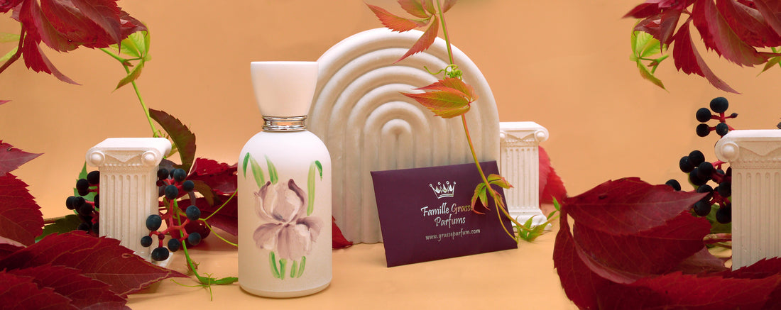Les Fleurs de Grasse Iris bottle surrounded by autumn leaves and decorative columns
