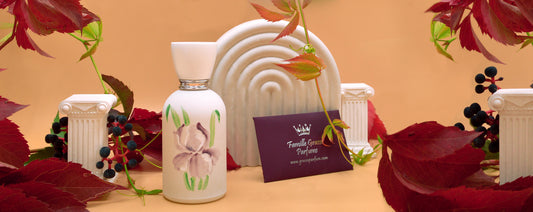 Les Fleurs de Grasse Iris bottle surrounded by autumn leaves and decorative columns