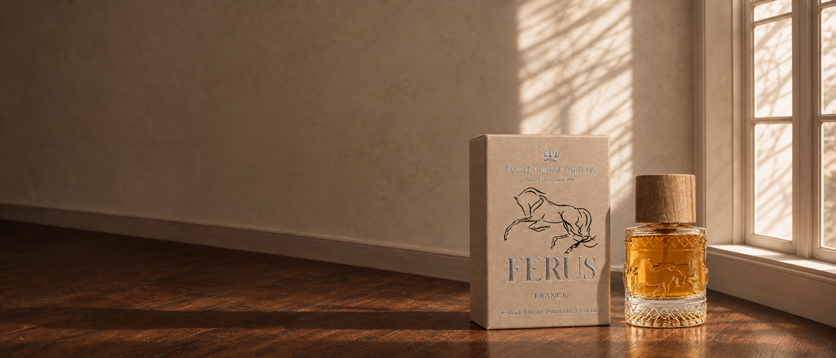 A model holding Ferus perfume in warm window light, with the bottle and its presentation box in the foreground.